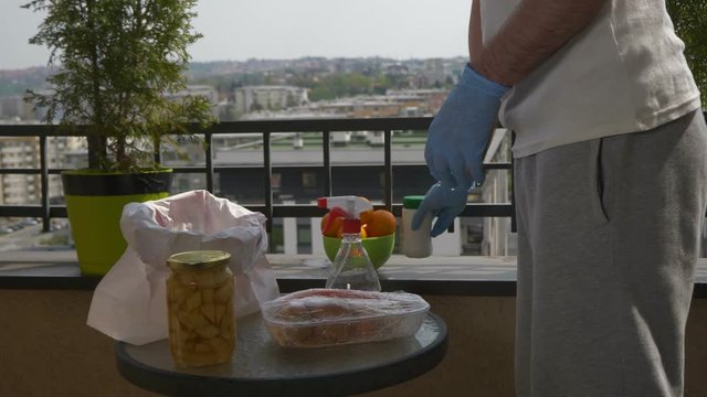 Man disinfecting groceries during pandemic virus, timelapse