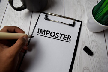 Imposter write on clipboard isolated on Office Desk
