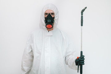 Virologist is weaing in protective clothe during coronavirus pandemic, portrait. Suit, mask, gloves and glasses on white background in office