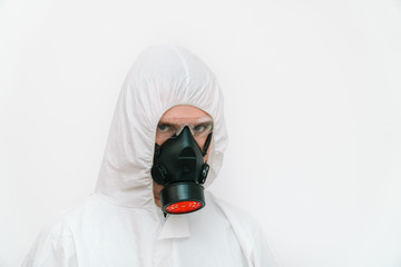 Man in protective coverall and respirator on white 