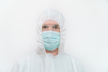 Portrait of a virologist in blue mask and protective coverall