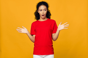 Emotional woman red t-shirt studio lifestyle yellow background