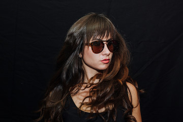 Long-haired brunette woman on black background