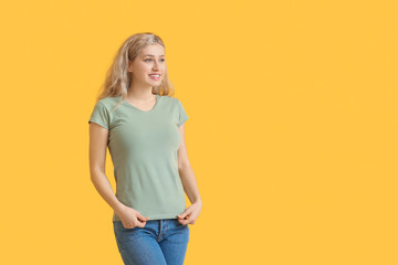 Woman in stylish t-shirt on color background