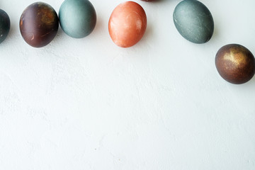 painted eggs on white stone   backround,. Happy easter concept. Natural colorful egg, pastel and natural color.