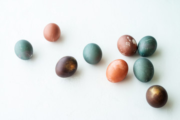 painted eggs on white stone   backround,. Happy easter concept. Natural colorful egg, pastel and natural color.