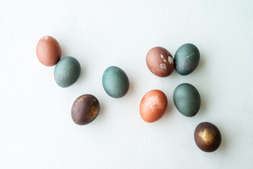 painted eggs on white stone   backround,. Happy easter concept. Natural colorful egg, pastel and natural color.