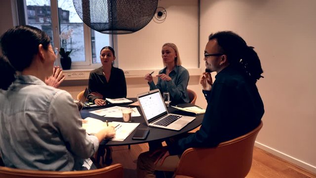 Diverse businesspeople
talking together during a late
office meeting
