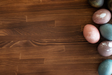 Happy easter egg. set of Holiday eggs on  brown wooden   backround, copy space. Natural  colorful eggs painted in pastel colors , happy Easter concept.