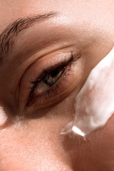 large clan. applied to the girl a face cream made from natural ingredients