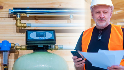Engineer on the background of the water treatment system in the house. Engineering communications...