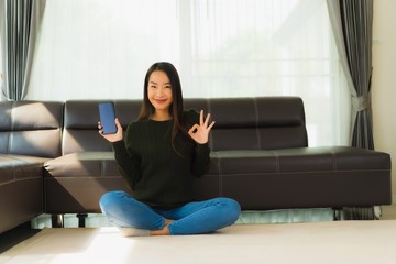 Portrait beautiful young asian woman use smart mobile phone with coffee cup