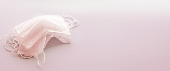 Set of white medical masks banner. Pink background. Face mask protection against pollution, virus, flu and coronavirus. Health care  concept, copy space, free space for text