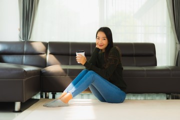 Portrait beautiful young asian woman use smart mobile phone with coffee cup