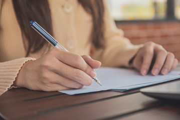 Fototapeta premium Close up hand writing on document business women working from home