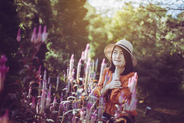 Portrait of beautiful asian woman with flowers at garden,Happy and smiling,Relaxing time,Travel at...