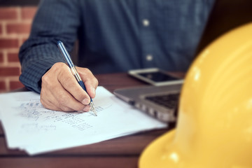 Businessman holding pen writing on paper document working,Close up hand write paperwork
