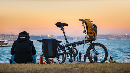 resting bicycler and his bicycle, sea background, bosphorus, boats, istanbul