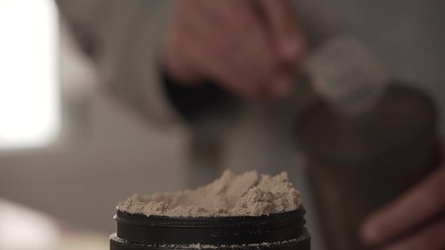 Serving A Portion Of Protein Powder Into The Shaker bottle