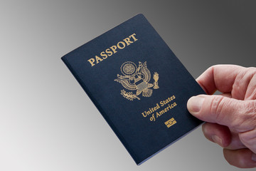 United States Passport, Close-Up With Hand, Grey Background