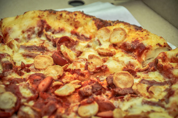 A Pan of pizza full with meat and cheese topping.