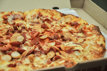 A Pan of pizza full with meat and cheese topping.