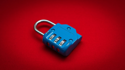 blue combination padlock over red background