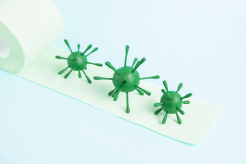 Green model of coronavirus on the toilet paper roll.