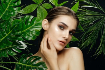 Beautiful woman green leaves Exotic bare shoulders luxury spa treatments