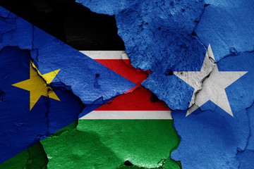 flags of South Sudan and Somalia painted on cracked wall