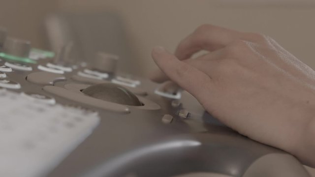 ultrasound doctor examines a pregnant girl, belly of a pregnant girl