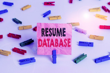Conceptual hand writing showing Resume Database. Concept meaning database of candidates that you can search by skillset Colored clothespin papers empty reminder white floor office