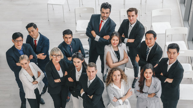 business background of diverse businesspeople standing together in a group and having arms cross showing confident in conference room