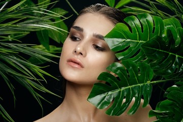 Beautiful woman green leaves Exotic tropics luxury model