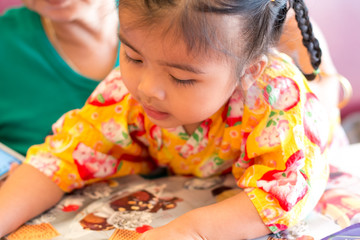 Portrait of Beautiful Asian toddler girl 2-3 years old Order ice cream menu