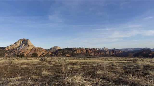 A wide sunset timelapse of an area of grassland along Kolob Terrace Road in Zion National Park. Snow nestling in the north face of Pine Valley Peak contrasts with the white rock as the sun sets.