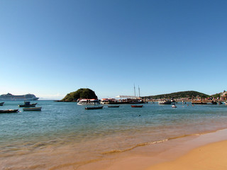 Boats anchored in the clear, placid waters of Búzios Bay