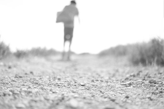 Surface Level Shot Of Woman Standing Amidst Barren Landscape