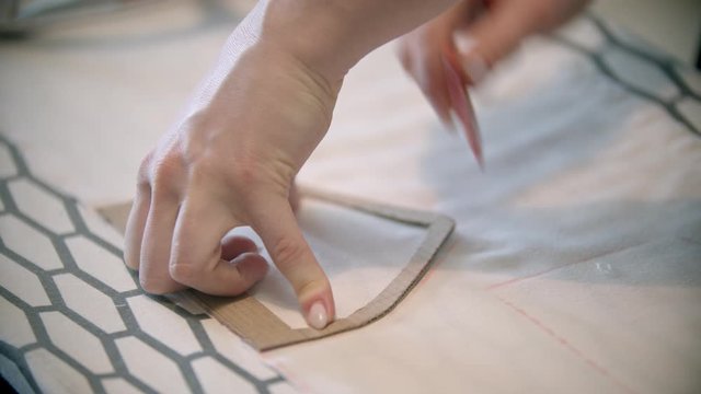 Young woman seamstress making marks using the soap and form