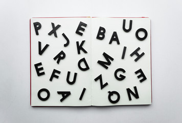 Close up to lettering over blank notebook at white background.  Reading and study concept photography