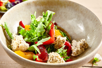 Salmon fillet salad in clay plate