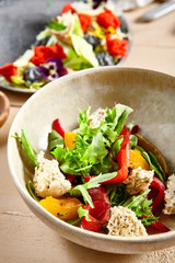 Salmon fillet salad in clay plate