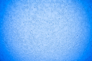 Rain droplets on blue glass background, Water drops on blue glass.