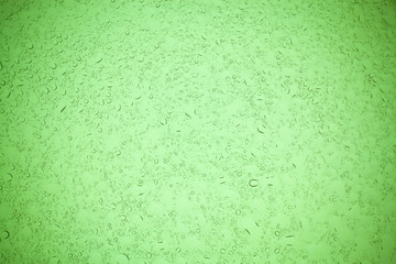 Rain droplets on green glass background, Water drops on green glass.