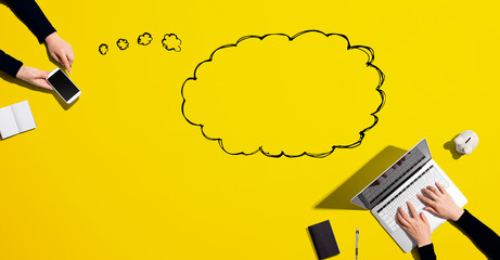 Blank speech bubble with people working together with laptop and phone