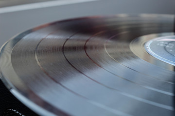 closeup to a black Vinyl Lp disc texture over turntable. music lover concept