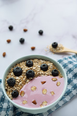 Healthy breakfast, bowl of oatmeal and yogurt with blueberries and almonds