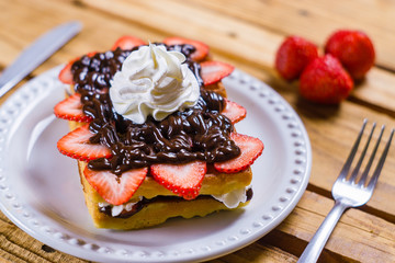 Strawberry dessert with chocolate and whipped cream