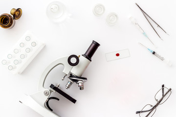 Bood testing with microscope in laboratory. Equipment on white background top view