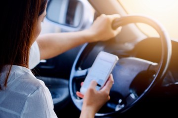Using or playing mobile phones while driving May cause an accident.